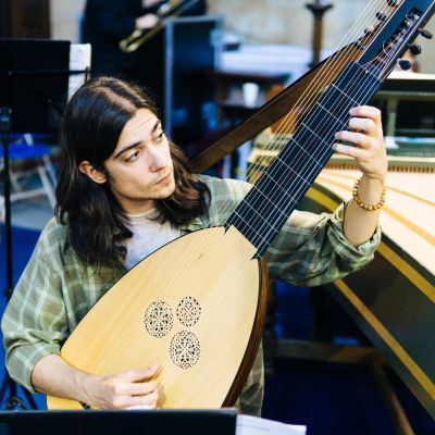 Guildhall theorbo player rehearsing in a church